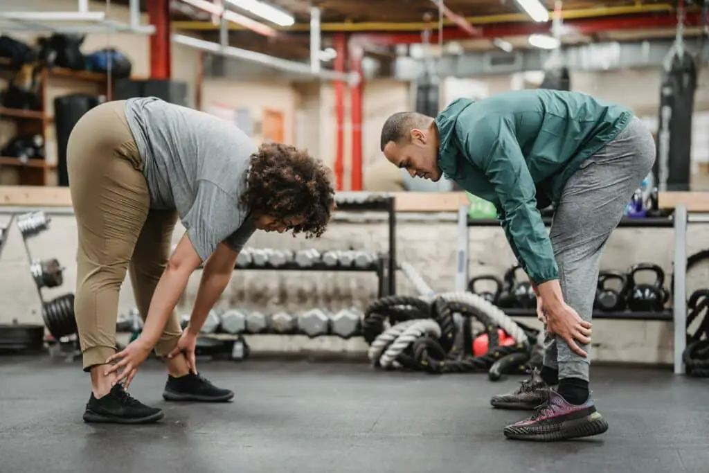 Title: 5 Natural Ways to Reduce Stress and Anxiety 3 A man and woman exercising in the gym