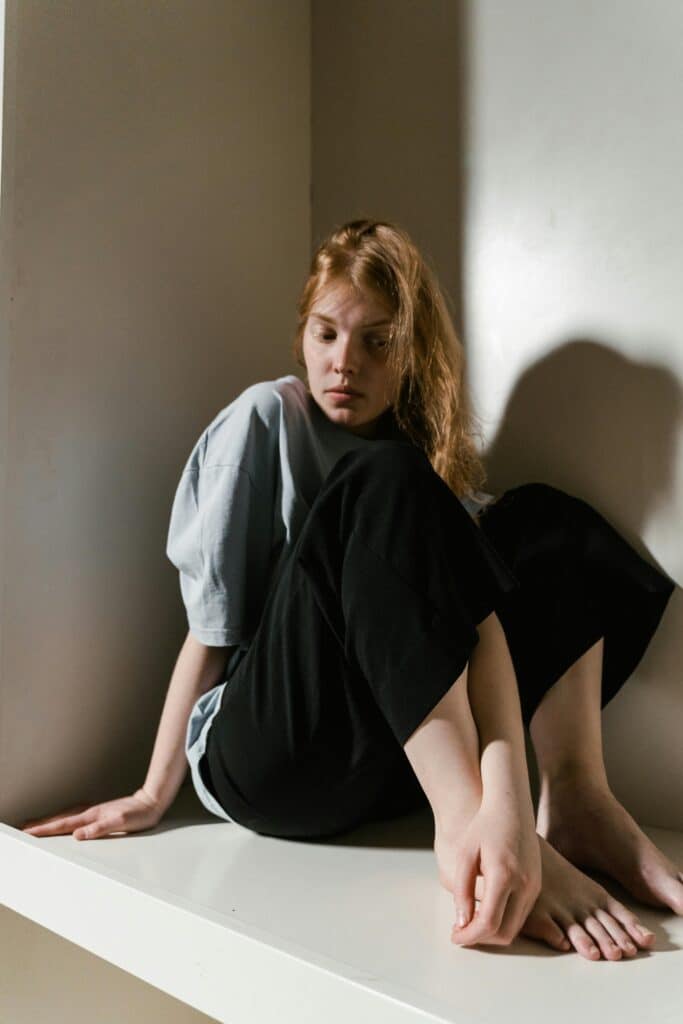 Title: 5 Natural Ways to Reduce Stress and Anxiety 1 woman sitting down trying to reduce stress