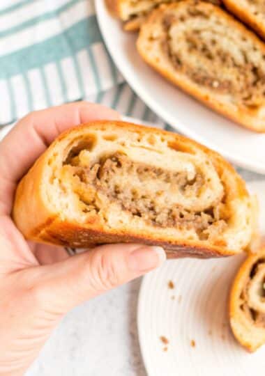 Sliced golden-brown Mozzarella Sausage Bread showing the savory filling swirl