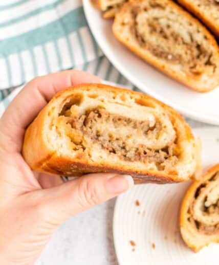 Sliced golden-brown Mozzarella Sausage Bread showing the savory filling swirl