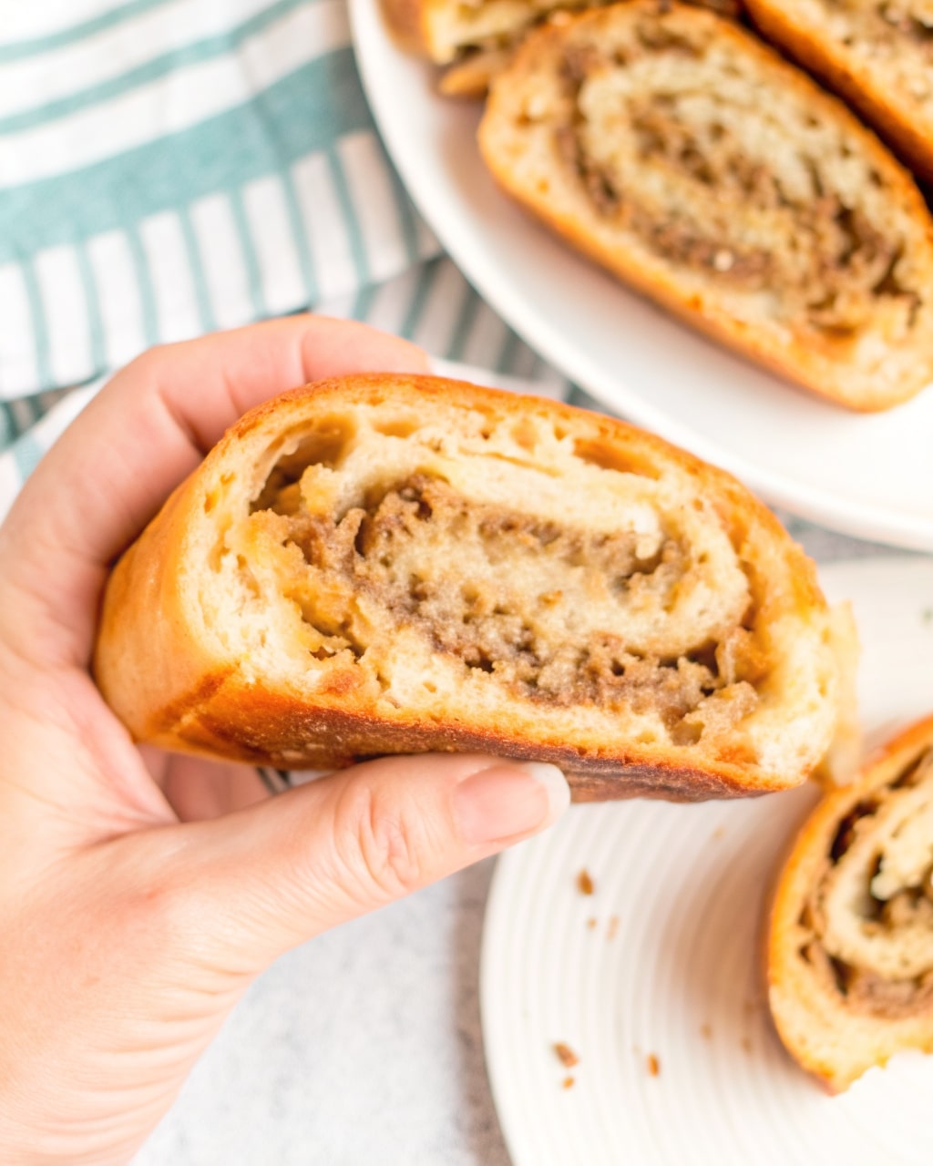Sliced golden-brown Mozzarella Sausage Bread showing the savory filling swirl