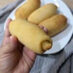 Freshly baked Filipino Spanish Bread rolls with coffee