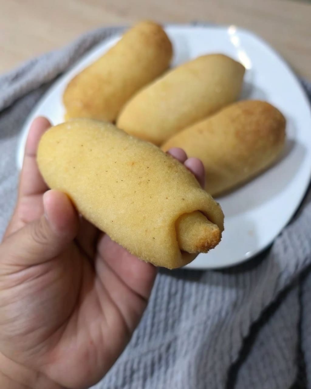 Freshly baked Filipino Spanish Bread rolls with coffee